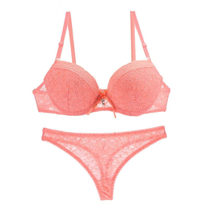 Sexy lace bra and panty set in coral pink with delicate floral pattern and adjustable straps