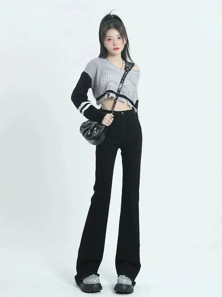Woman wearing retro high waist black raw hem long slightly flared jeans with