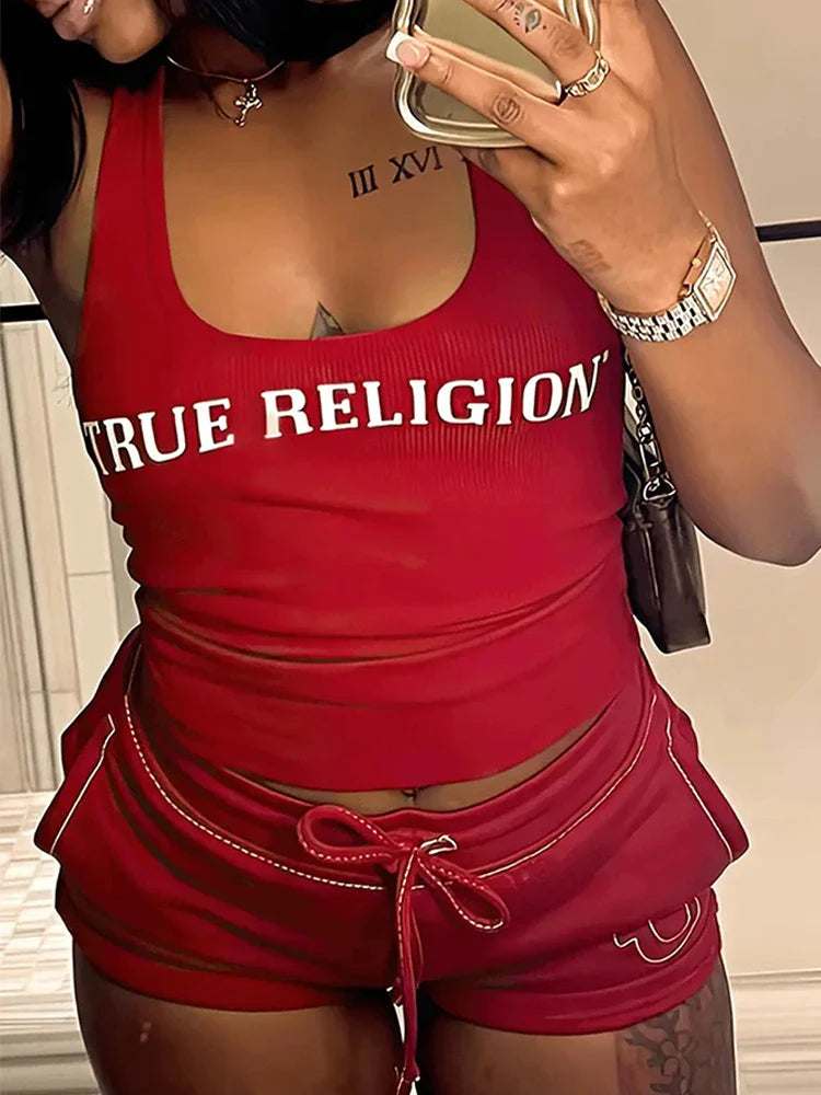 woman wearing red summer ribbed 2 piece crop top and shorts set with true religion logo