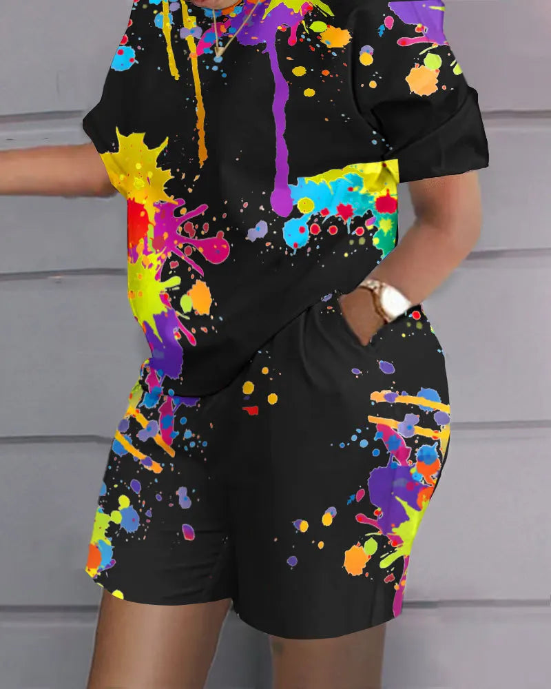 Black summer casual 2-piece outfit with colorful paint splatter print, short sleeves, and shorts with pockets.