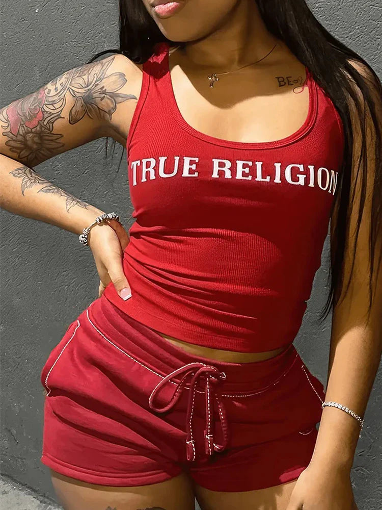 Woman wearing red Summer Ribbed 2 Piece crop top and shorts set with "TRUE RELIGION" text on top