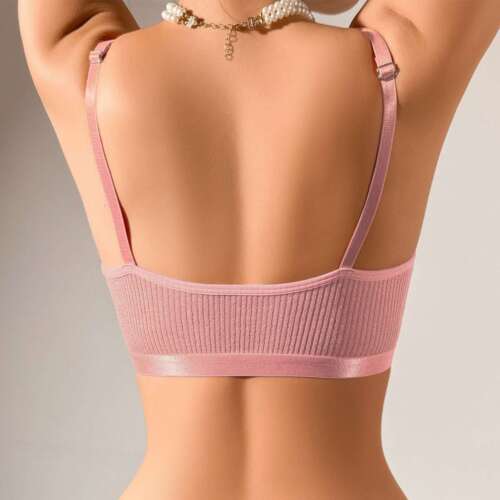 Back view of a woman wearing a pink women's sexy lace bralette crop top with adjustable straps and ribbed texture.