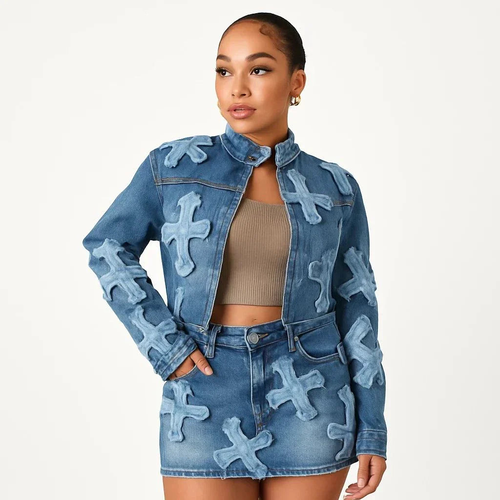 woman wearing chic denim tassel two-piece set with embroidered crosses and bodycon mini skirt