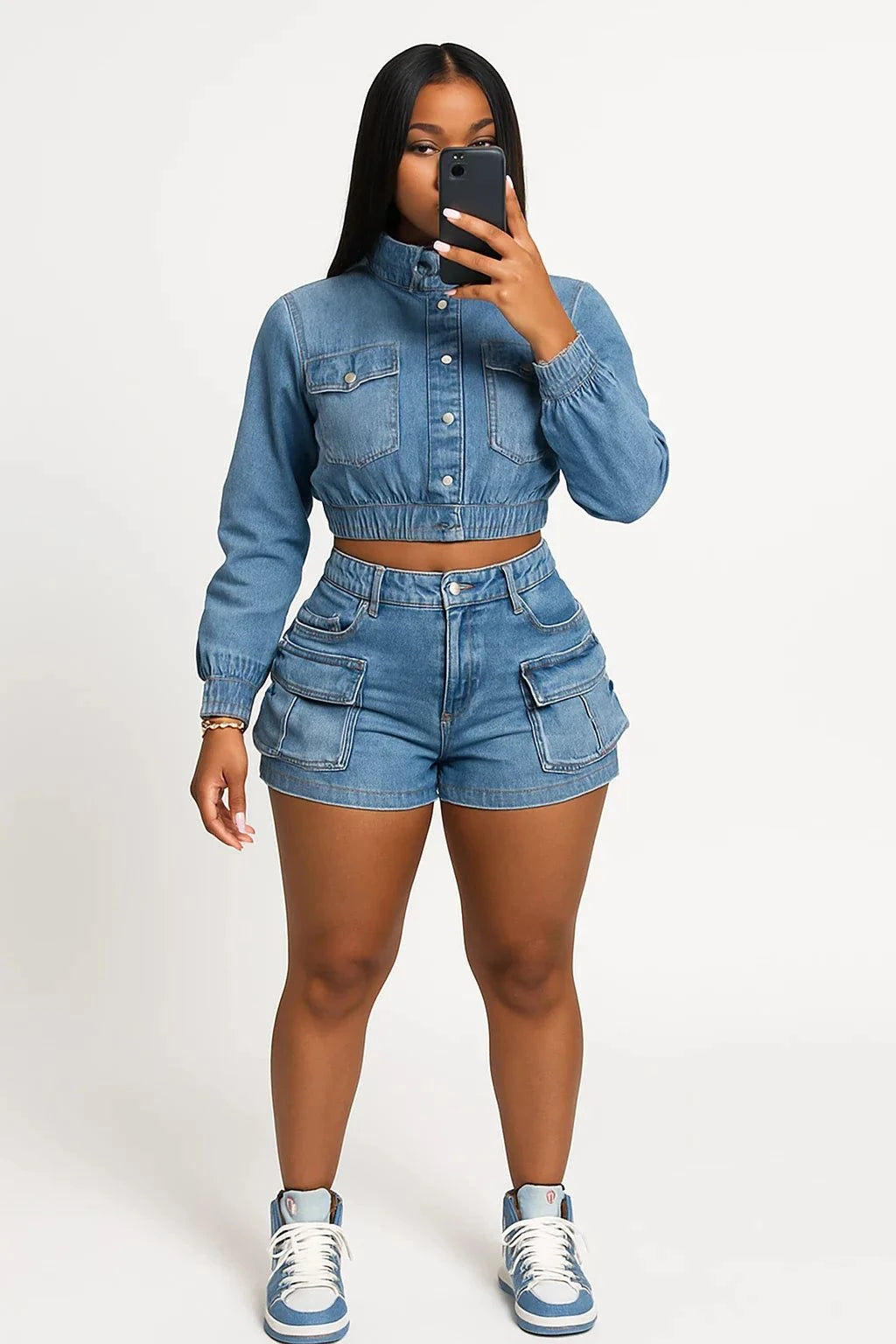 woman wearing chic multi pocket denim shorts set with matching cropped jacket taking selfie in mirror