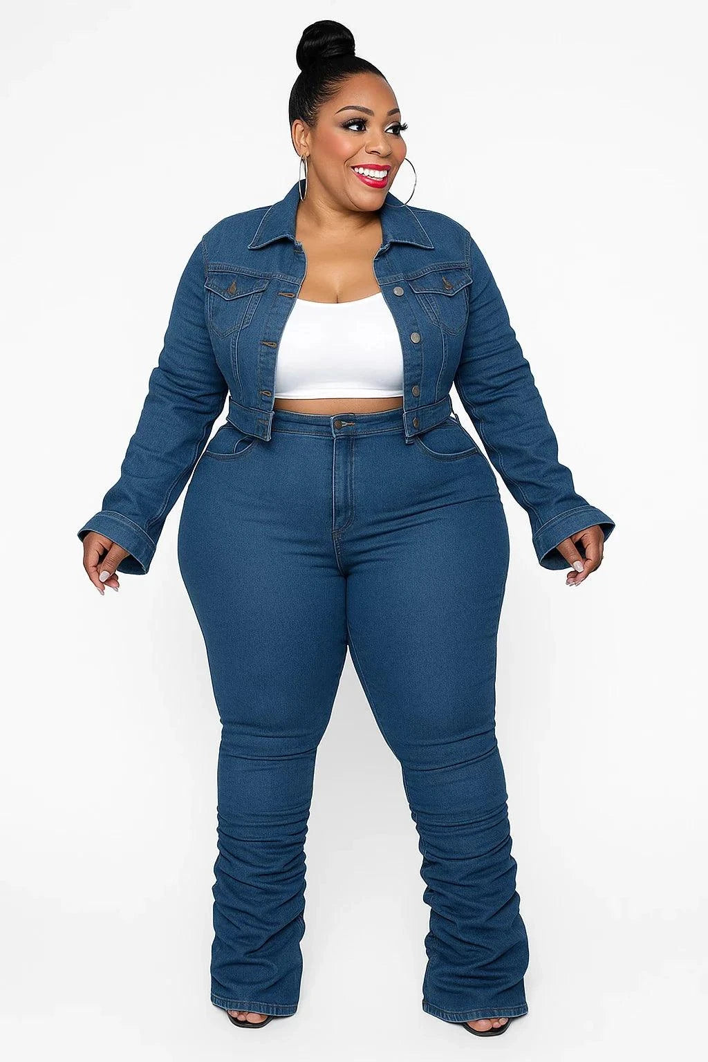 Curvy woman wearing chic plus size denim two-piece set with cropped jacket and ruched stacked jeans