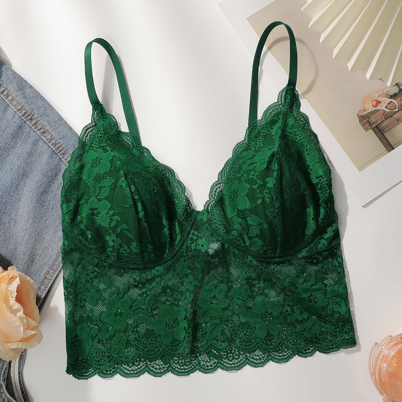 Green elegant floral lace bodycon bra with scallop trim and adjustable straps displayed on a white surface.