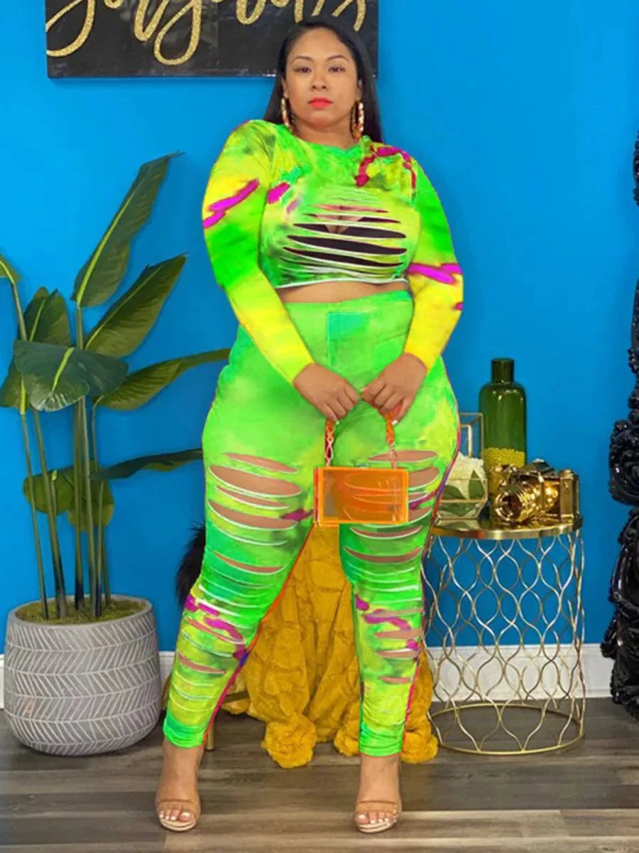 Plus size tie dye outfit with neon green and pink hues featuring cut-out details and long sleeves