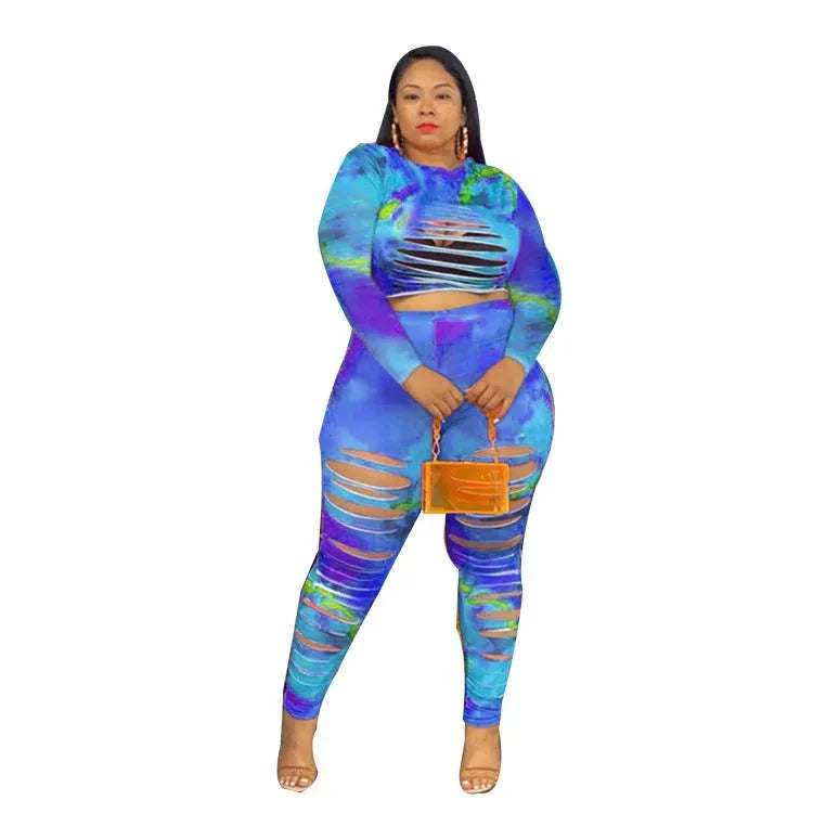 Plus size tie dye outfit with ripped long sleeve top and matching leggings in blue and purple tones