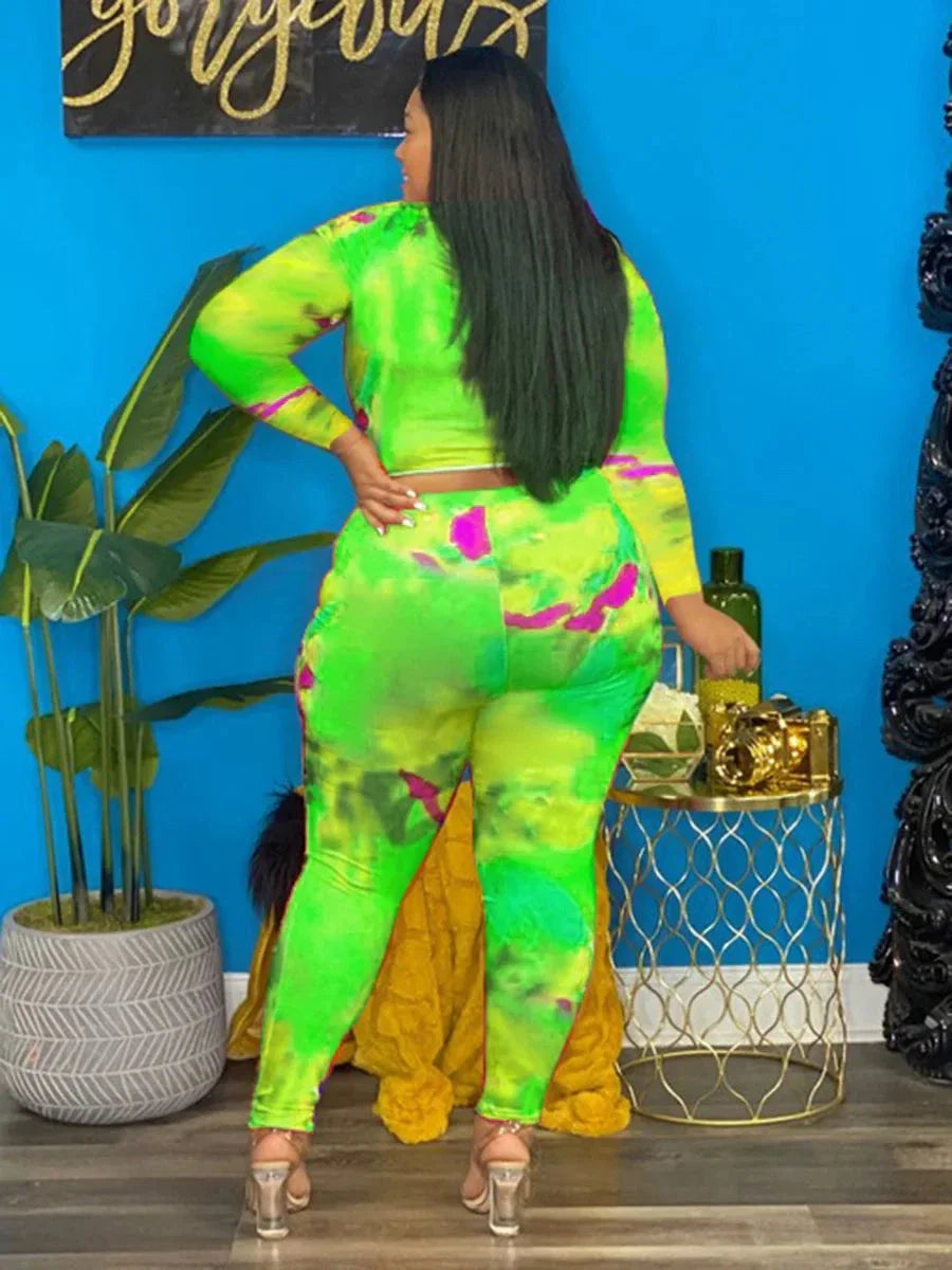 Plus Size Tie Dye vibrant green and pink long-sleeve outfit with fitted pants on woman standing indoors