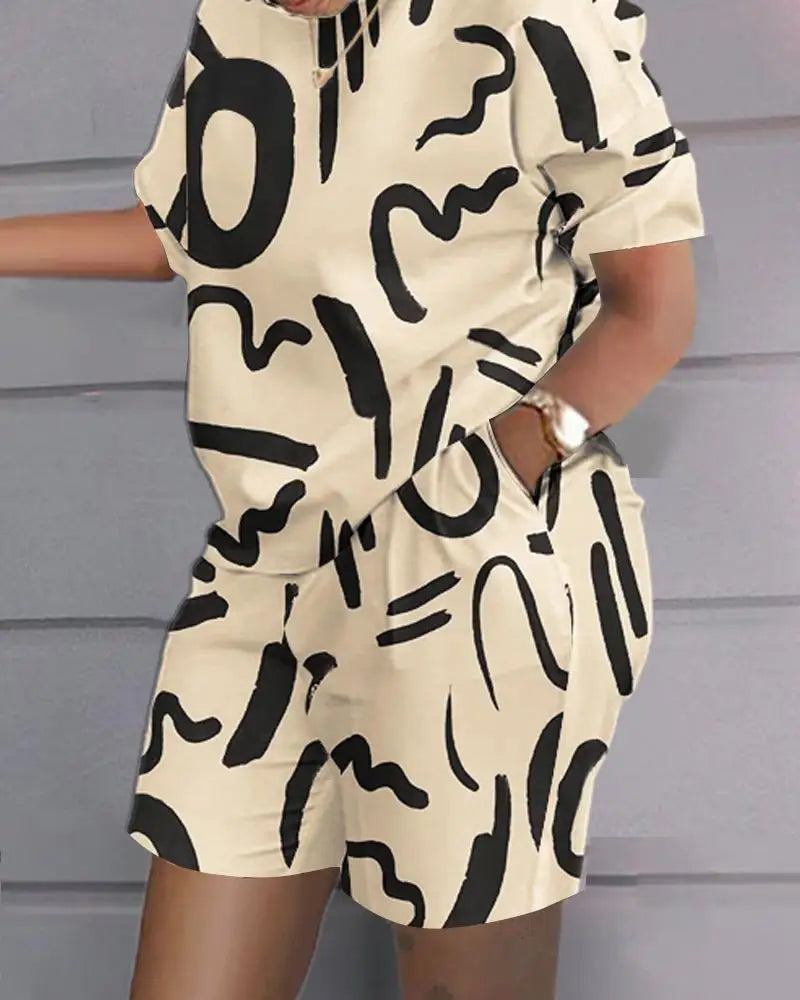 Summer casual 2-piece outfit for women with black abstract print on beige fabric, featuring a short-sleeve top and matching shorts with pockets.