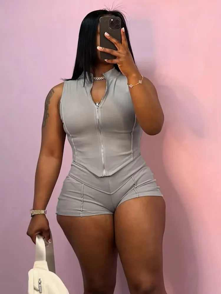 sporty chic patchwork sleeveless zip-up crop top and matching shorts set in light gray worn by woman taking mirror selfie