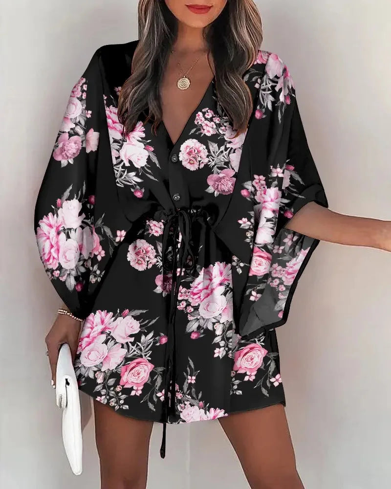 Black summer dress with pink and white floral fashion print, V-neck and lace-up waist design