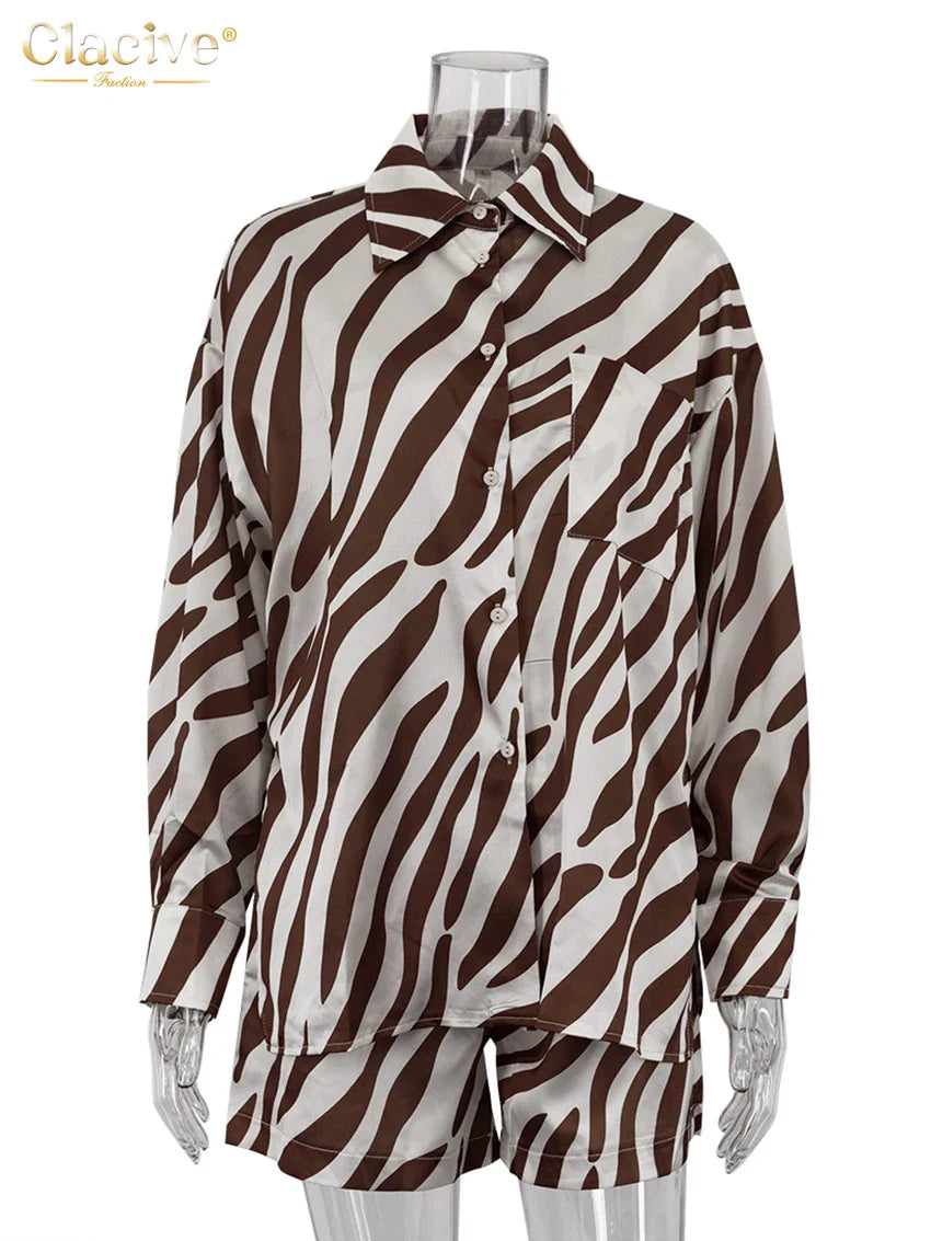 Elegant stripe print two-piece women's outfit with long sleeve shirt and high-waisted shorts in brown and white.
