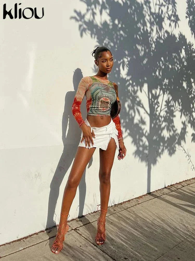 Kliou Dollar Print long sleeve mesh tee styled with white shorts and strappy heels outdoors