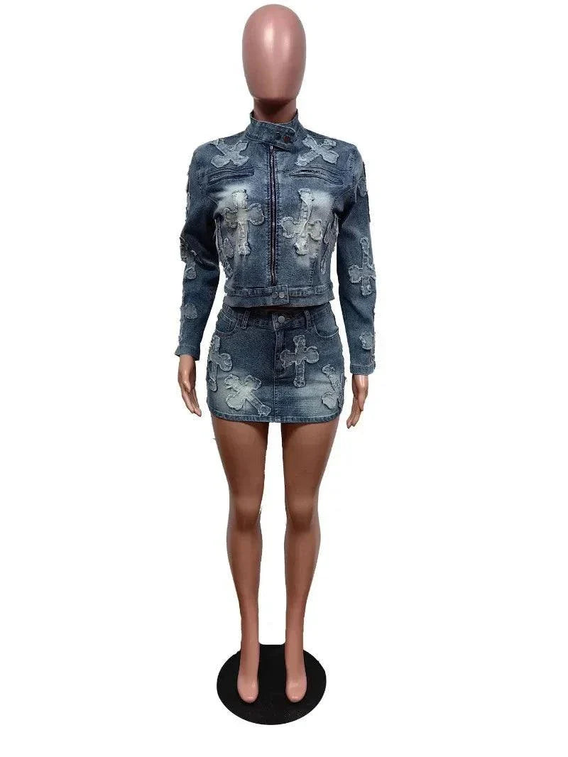 Chic denim tassel two-piece set for women featuring a bodycon mini skirt and a long-sleeve jacket with embroidered cross patterns.