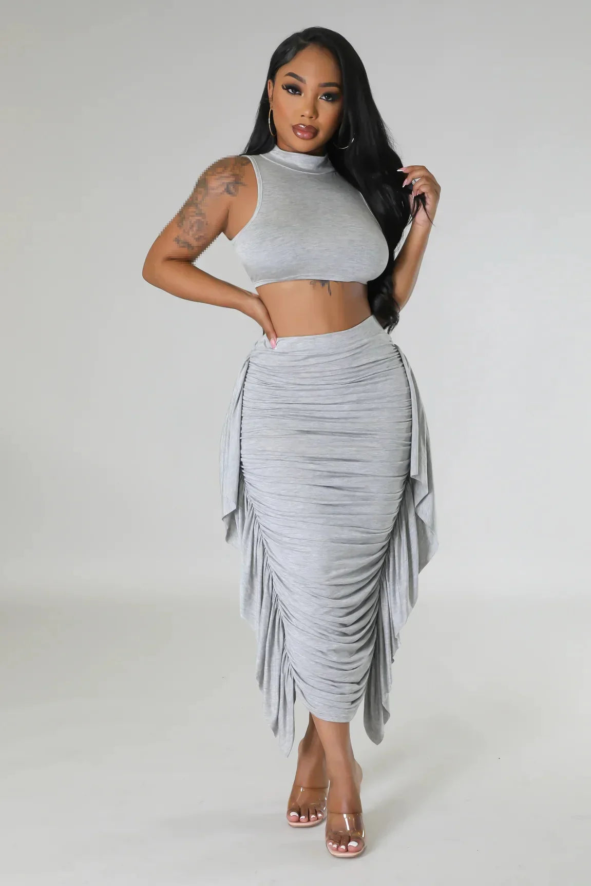 Woman wearing a stylish grey ruched two-piece summer set from the women’s summer collection.