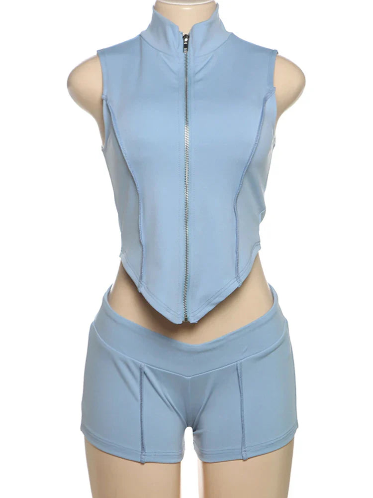 Light blue sporty chic patchwork sleeveless zip-up crop top and matching high-waisted shorts set on mannequin