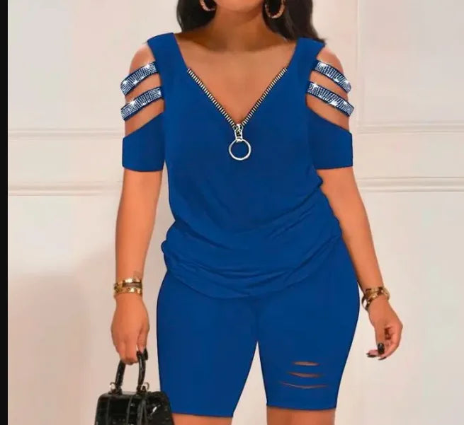 woman wearing blue summer casual hollow out two-piece set with zipper detail and strappy cold shoulder sleeves carrying black handbag