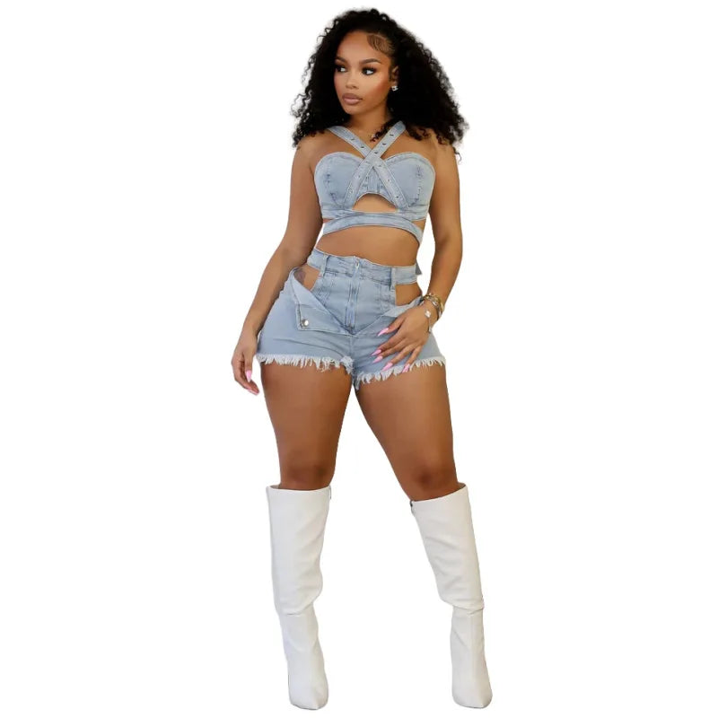 Woman wearing chic denim crop top with cutouts and matching shorts paired with white knee-high boots
