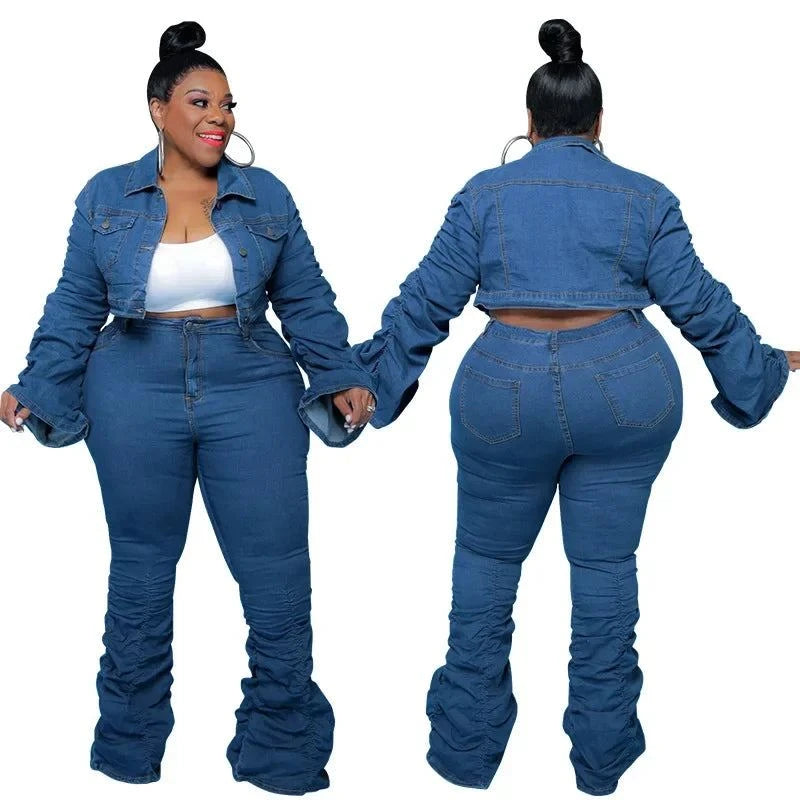 curvy woman wearing chic plus size denim two-piece set with puff sleeve cropped jacket and stacked jeans in blue