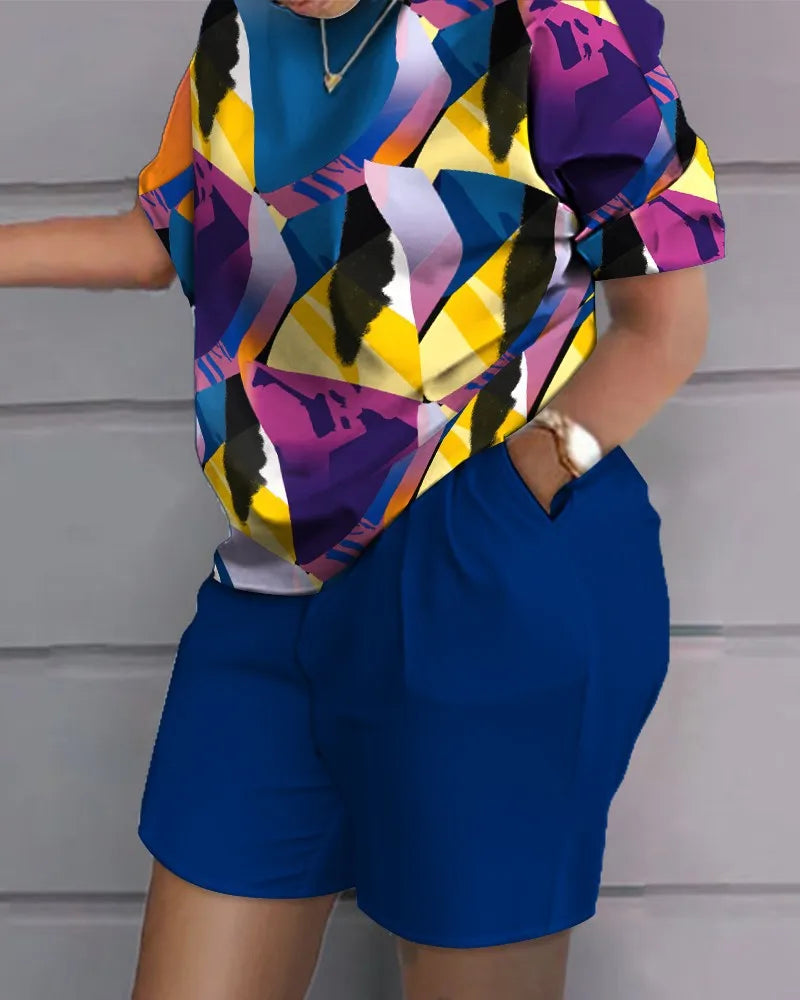 Woman wearing colorful geometric print short-sleeve top and solid blue shorts from summer casual 2-piece outfit